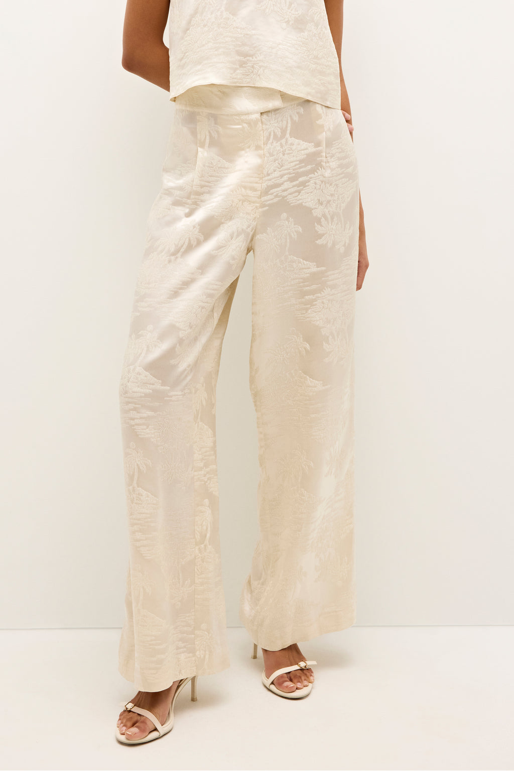 High waisted, wide leg cream pants with a subtle jacquard pattern