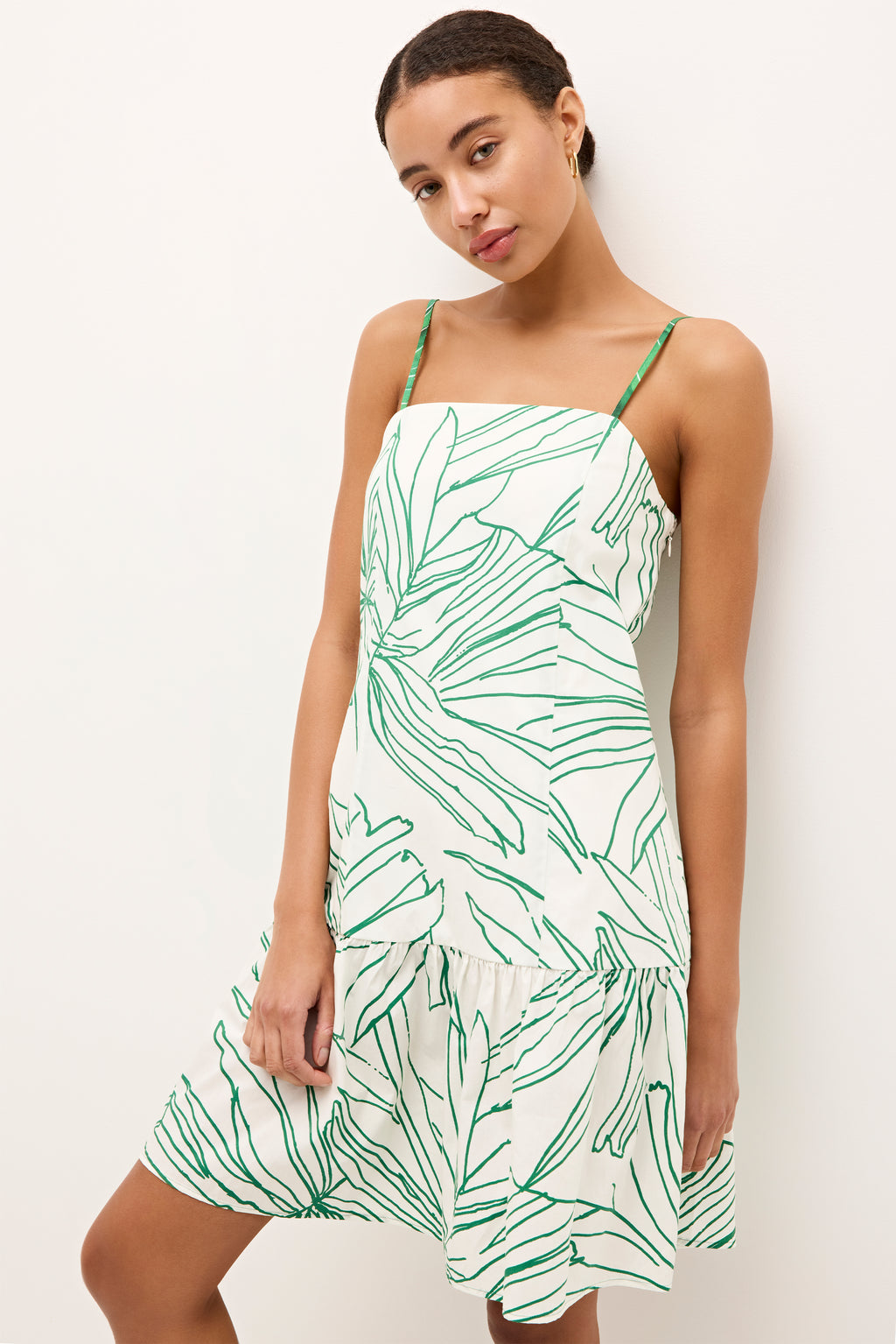 White mini dress with green abstract leaf print and spaghetti straps