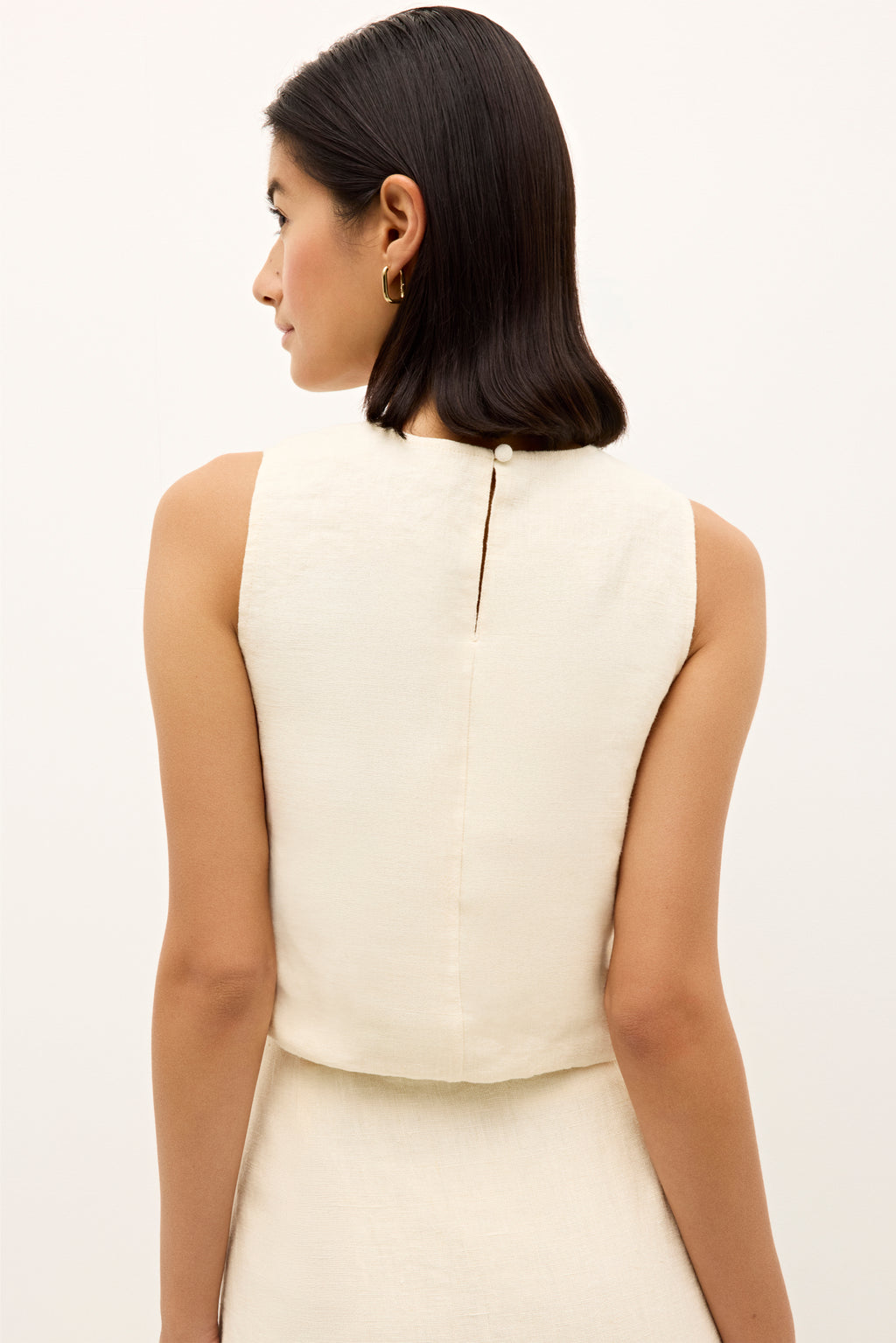 Ivory sleeveless top with bold multicolor geometric embroidery