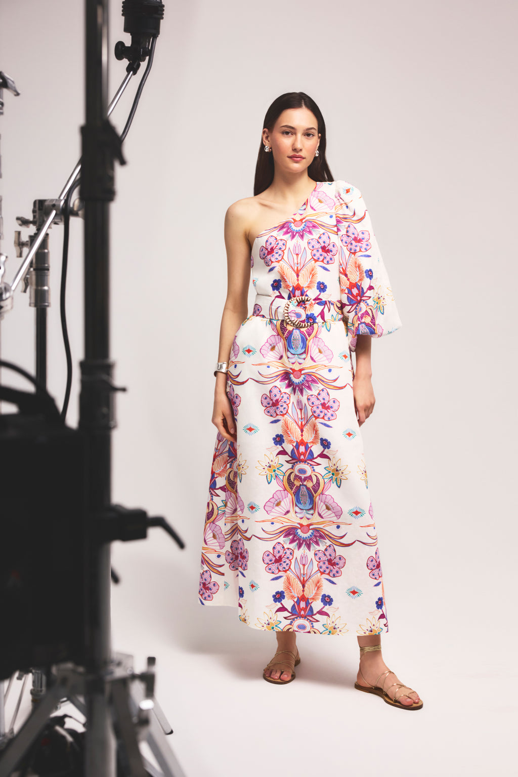 Symmetrical dress with a belted waist and bold, colorful botanical motifs