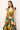 Colorful V-neck dress with dramatic shoulder ruffles and a flared tiered silhouette