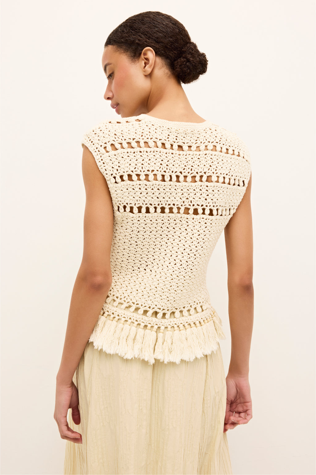 Textured ivory tank with intricate crochet pattern and tassel trim