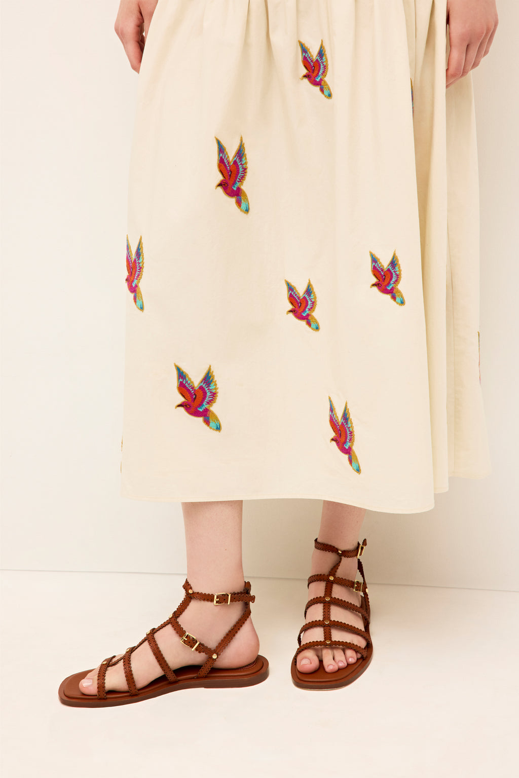 Cream midi skirt with playful multicolor bird accents and gathered waist