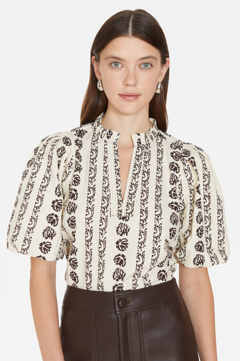 Elbow length top in an off white floral print 