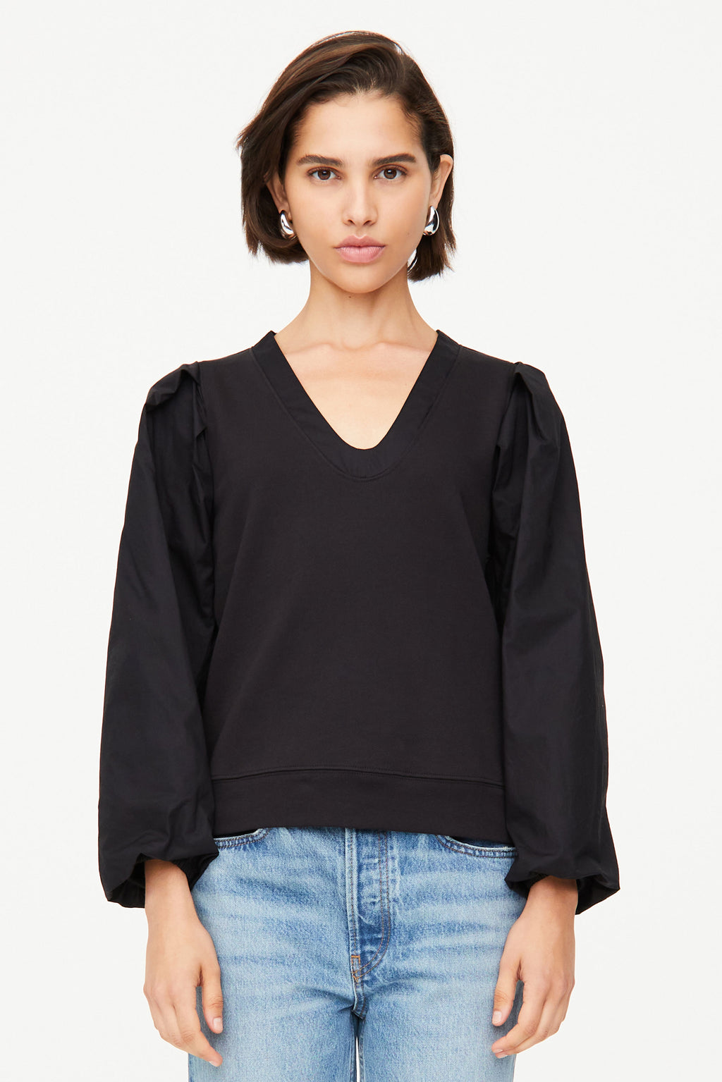 Black long sleeve top with  v-neckline and cuffed tie sleeves