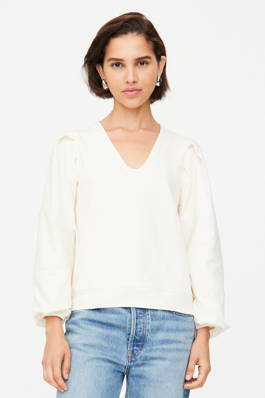 White long sleeve top with  v-neckline and cuffed tie sleeves