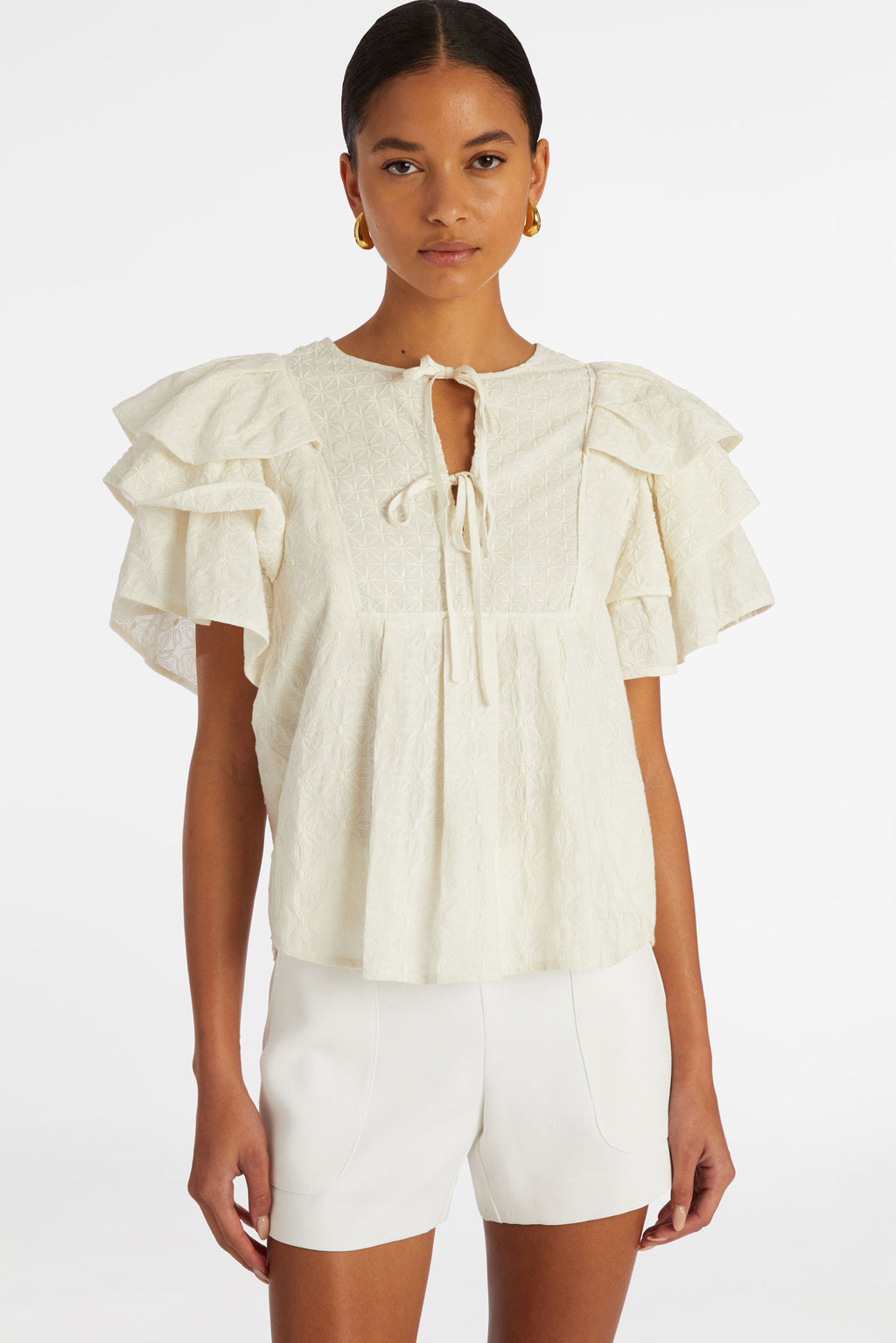 Top with an adjustable v-neckline in a solid white textured material