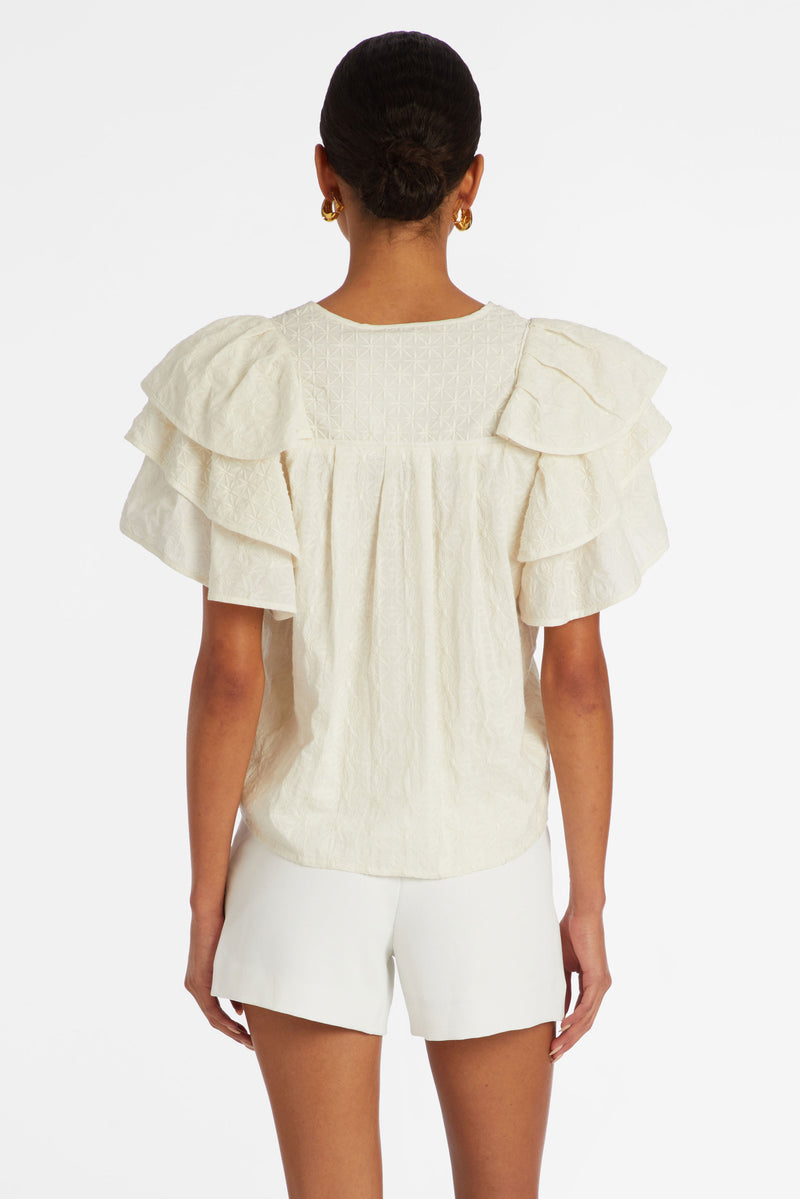 Short ruffle sleeve top in a solid white textured material