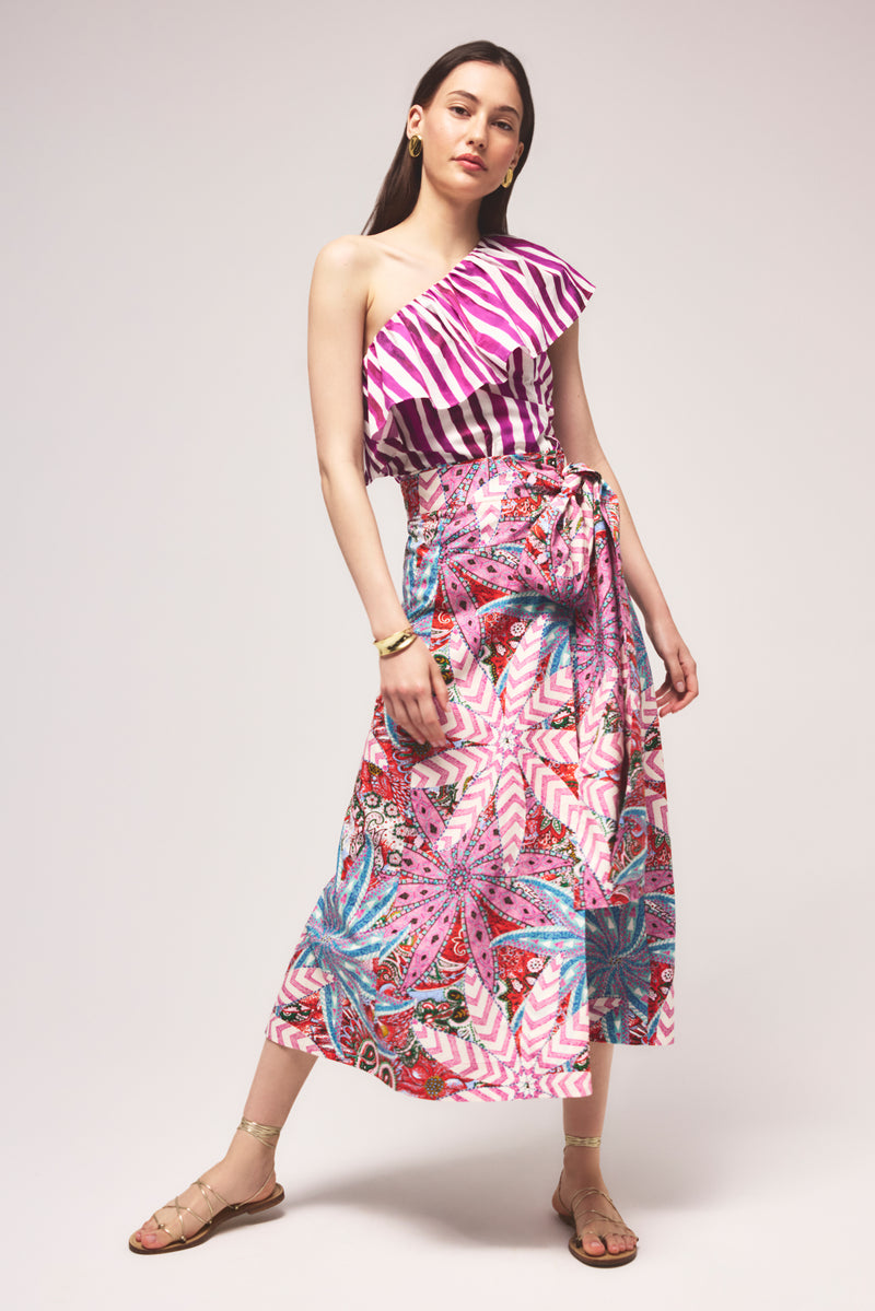 A- line wrap skirt with a kaleidoscopic floral and chevron pattern in pink, red, aqua, and purple tones 
