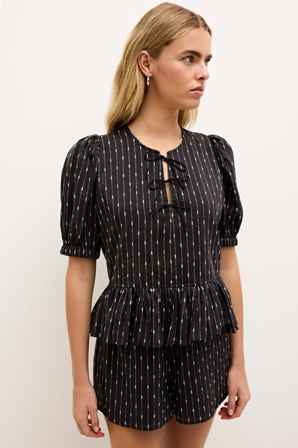 Striped cotton top with puffed shoulders and ruffled hemline 