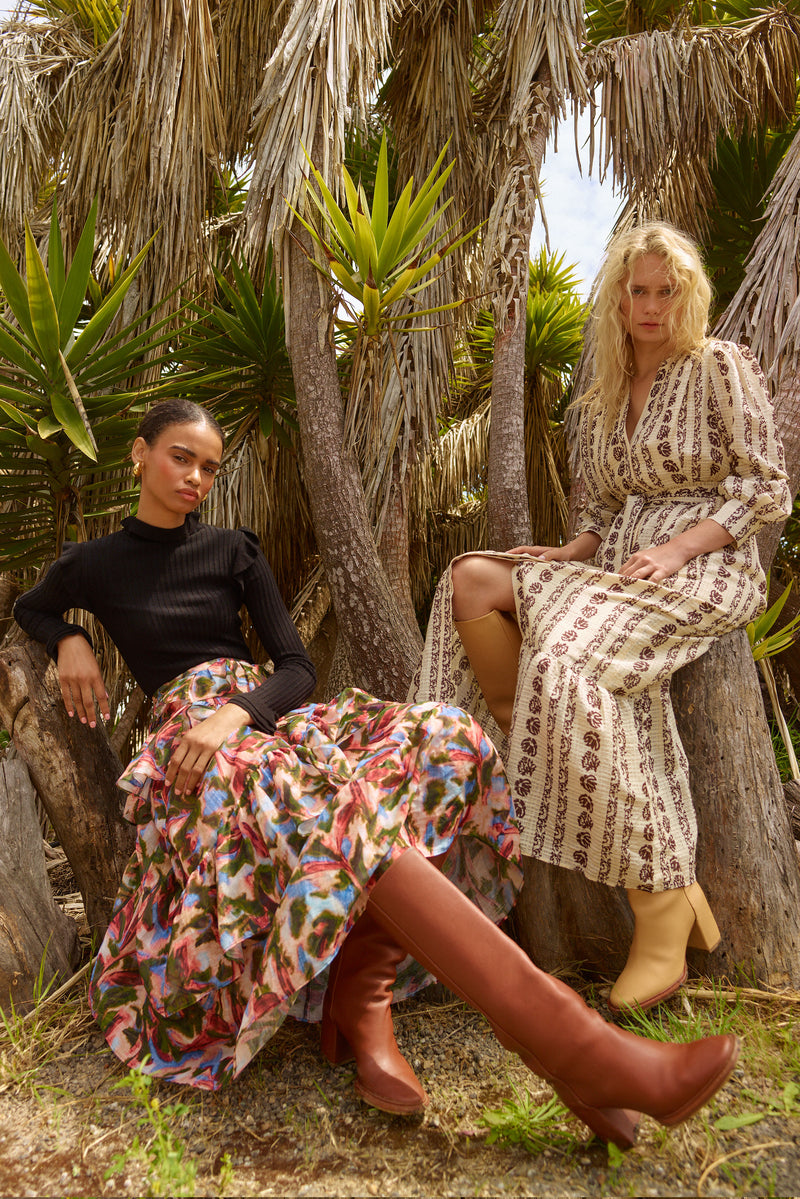 Long sleeve midi dress with black vertical floral print detail, v-neckline, and side seam pockets