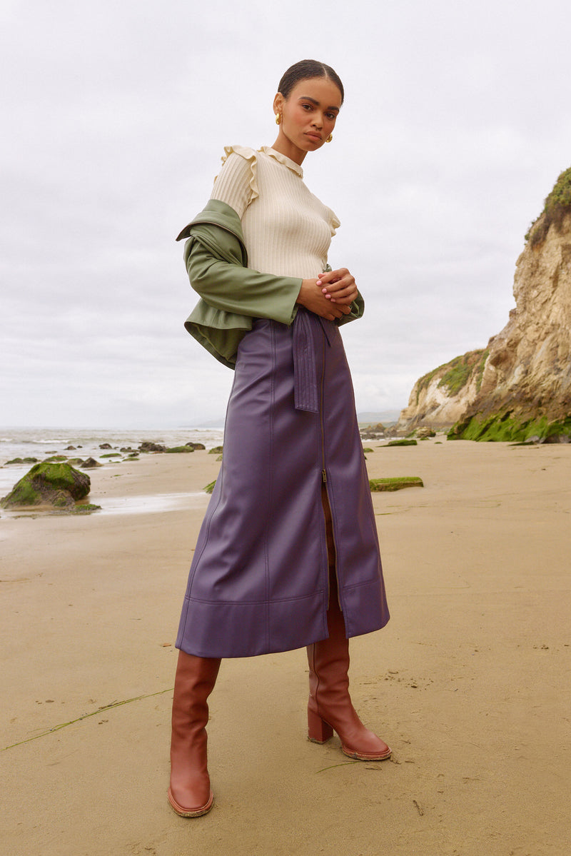 White ribbed turtleneck with ruffles on the shoulders and neck