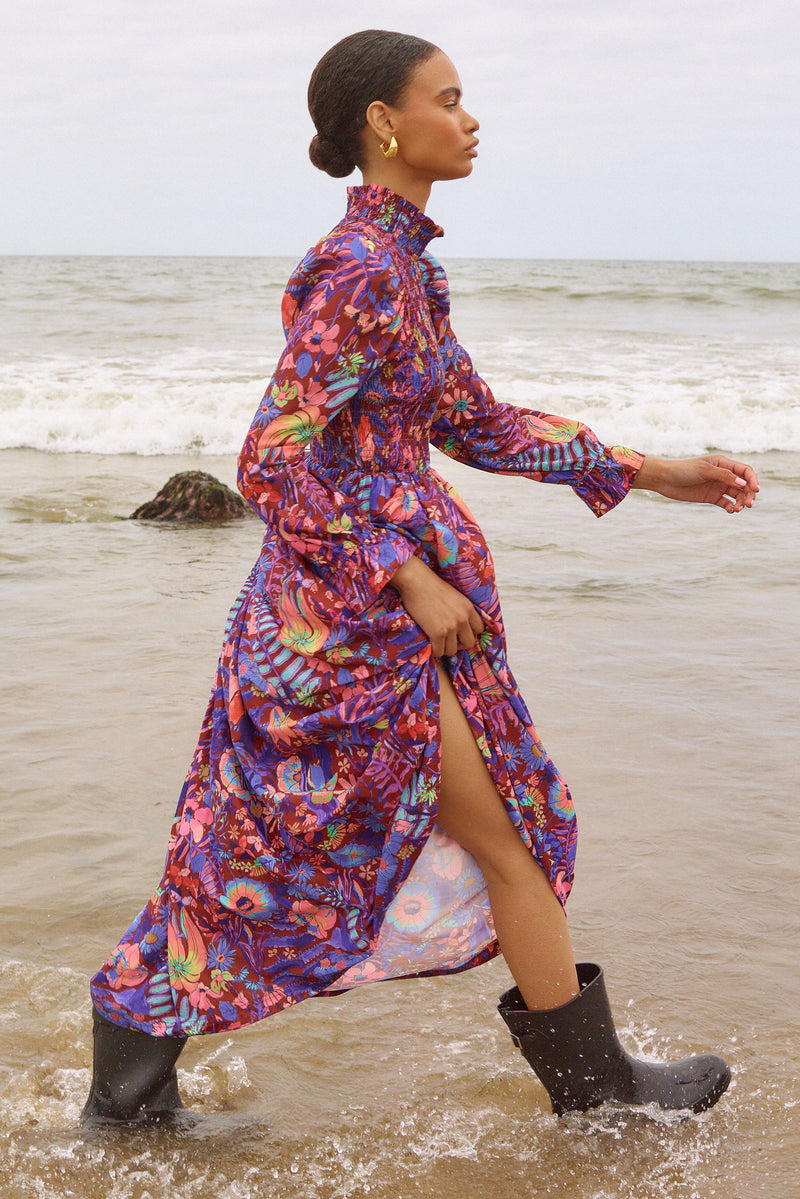 Midi dress with long cuffed sleeves, mock neckline, and smocked bodice in a bright floral print