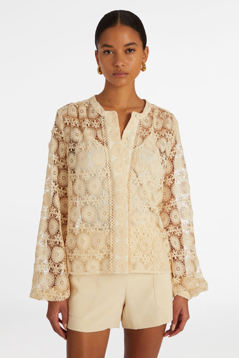 Solid cream floral lace blouse that buttons up the front and has a rounded neckline