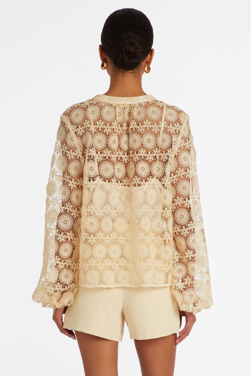 Solid cream floral lace blouse that buttons up the front and has a rounded neckline
