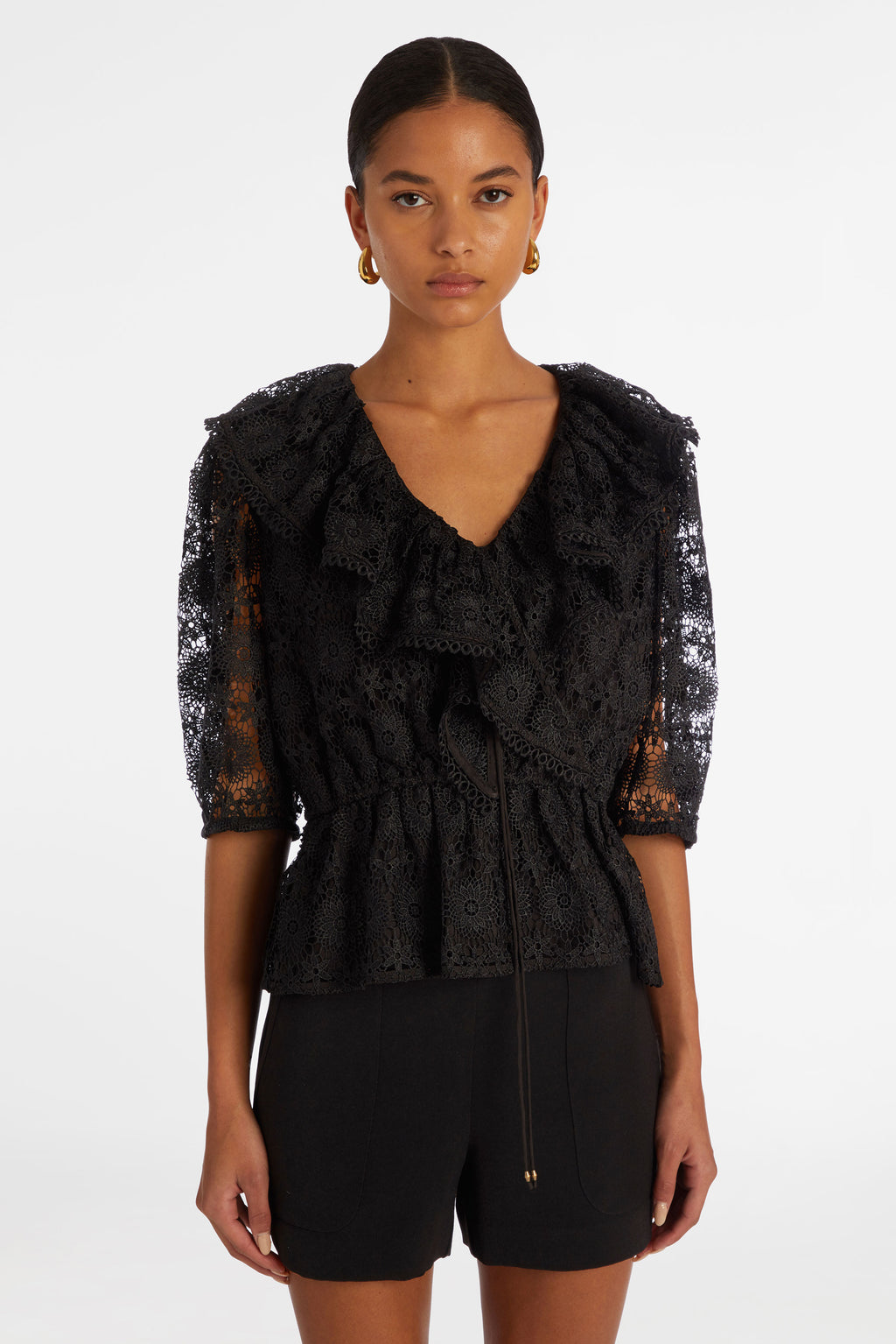 Top with three quarter sleeves in a solid black textured lace
