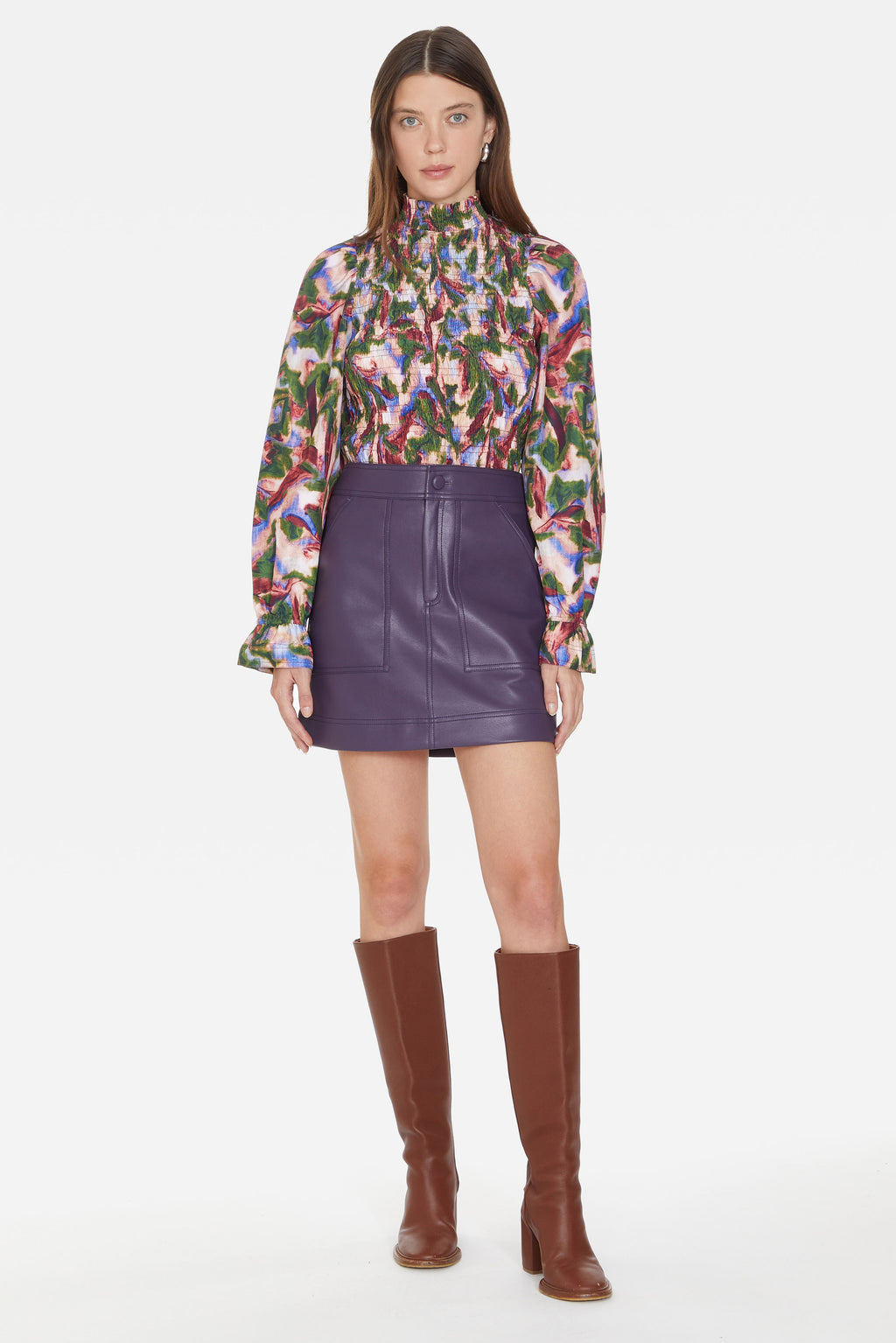 Leather skirt that sits at the natural waist with a thick waistband and zipper and button closure