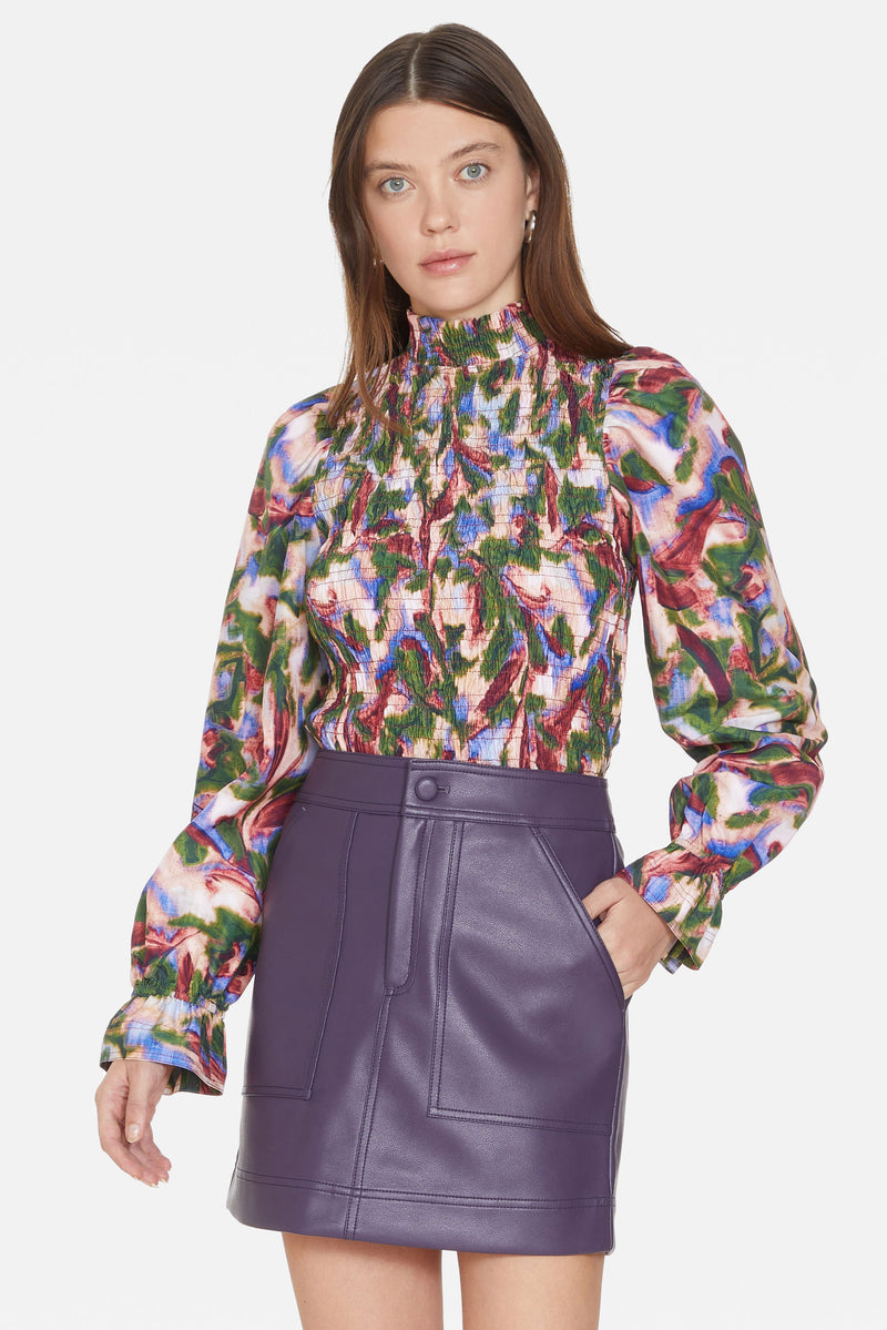 Short leather skirt with details of stitching down the front, patch pocket, and zipper fly with button front