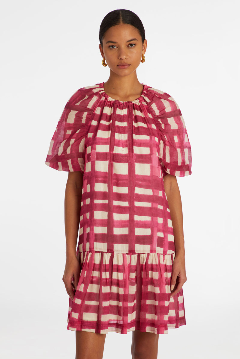 Mini dress in a pink and white plaid print with a flowy slip on silhouette 