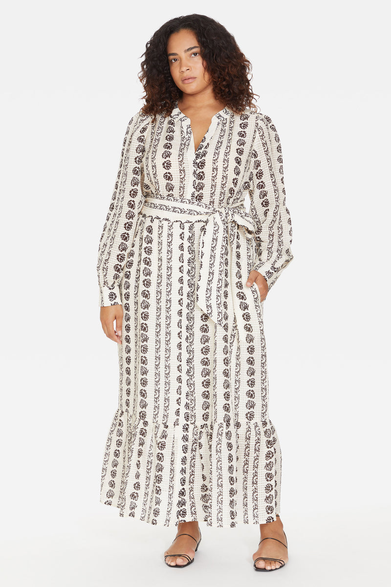 Long sleeve midi dress with black vertical floral print detail, v-neckline, and side seam pockets