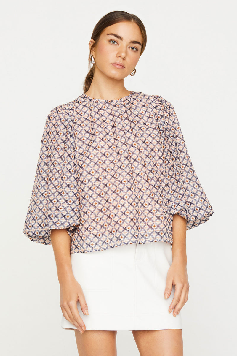 Puff sleeve top with rounded neckline, three-quarter sleeves, and relaxed silhouette