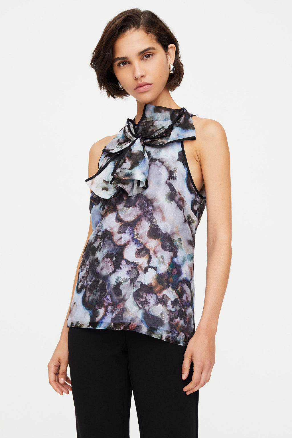 Sleeveless patterned top with bow in center 