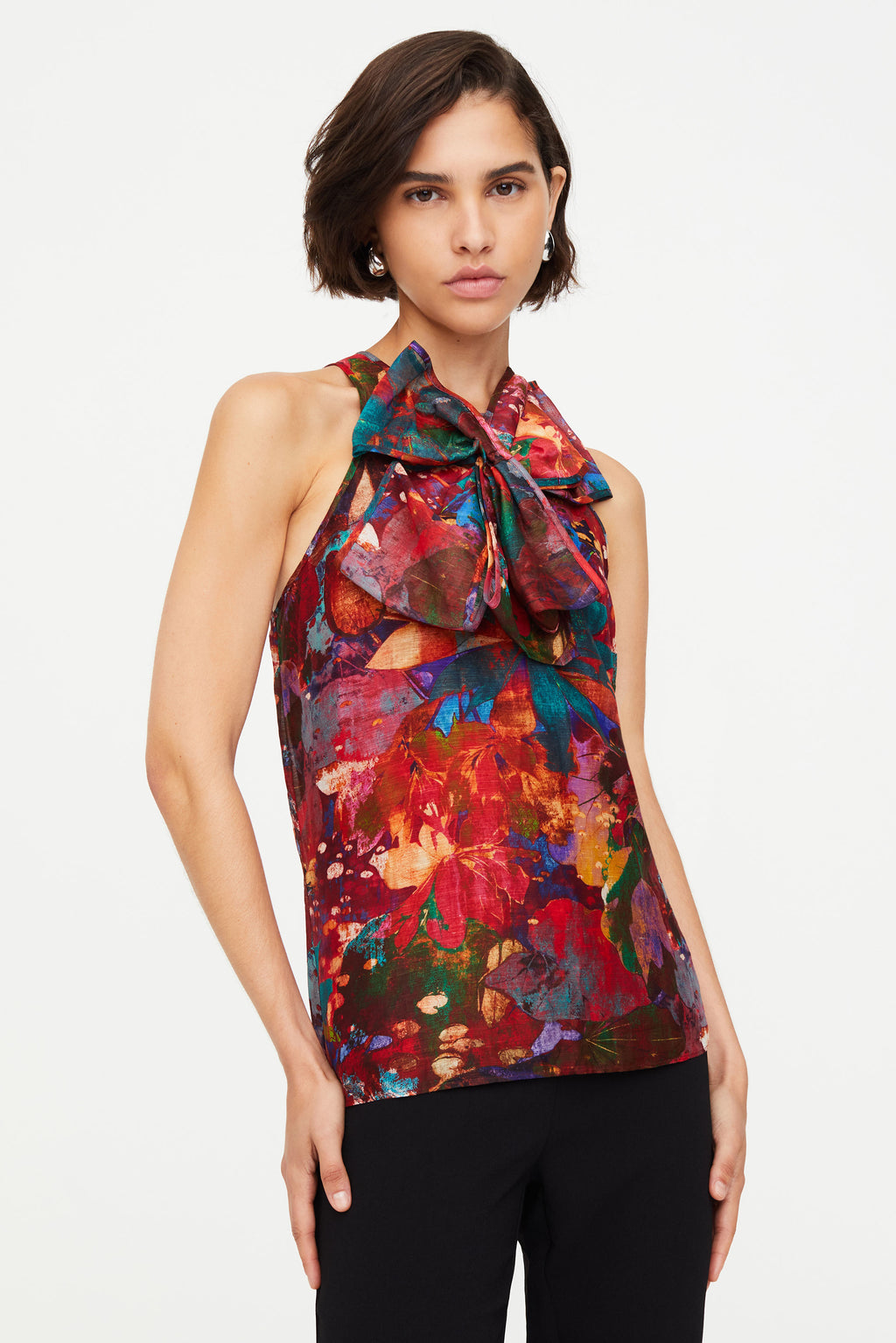 Sleeveless patterned top with bow in center 