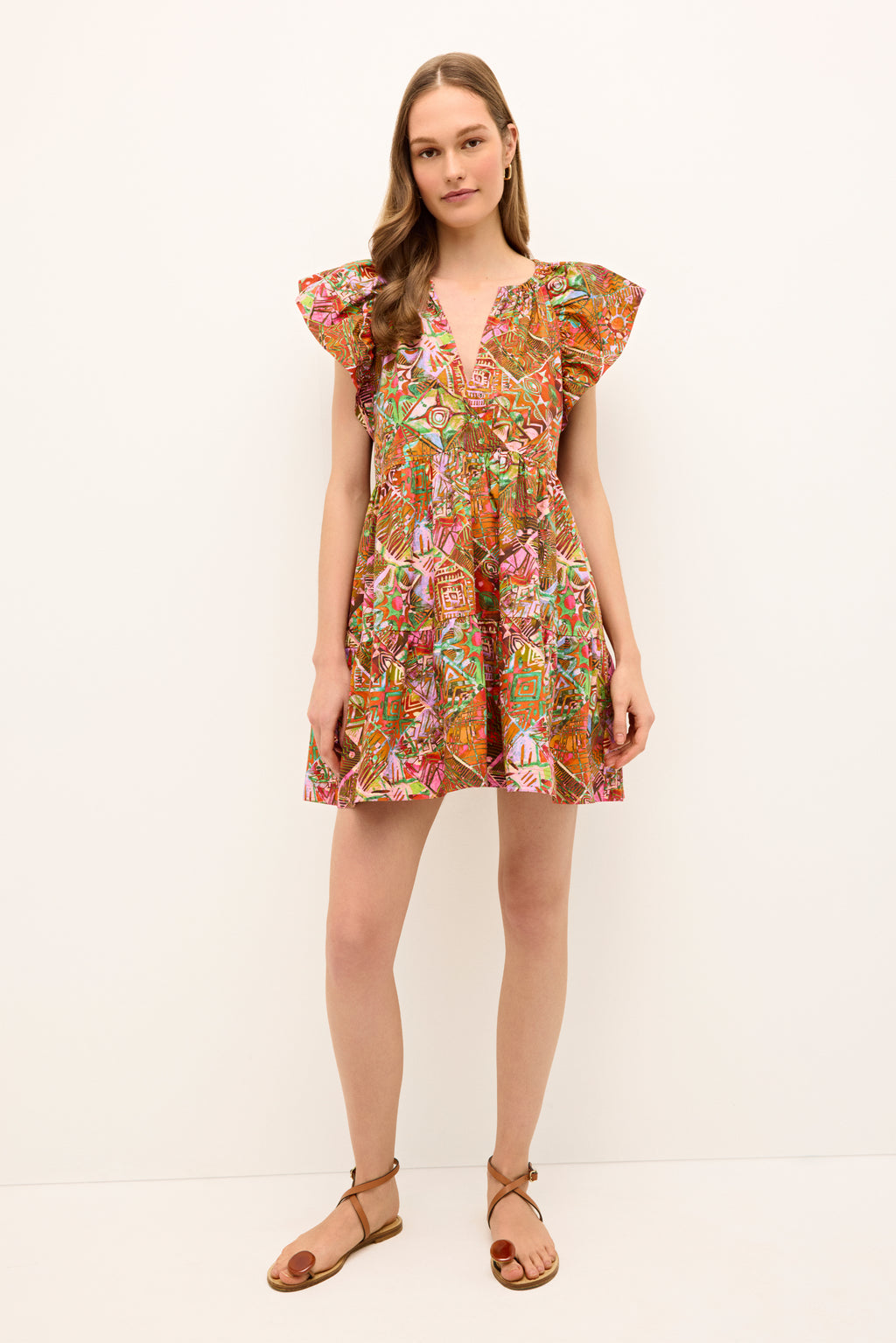 Short printed dress with a deep V-neckline and vibrant geometric motifs 