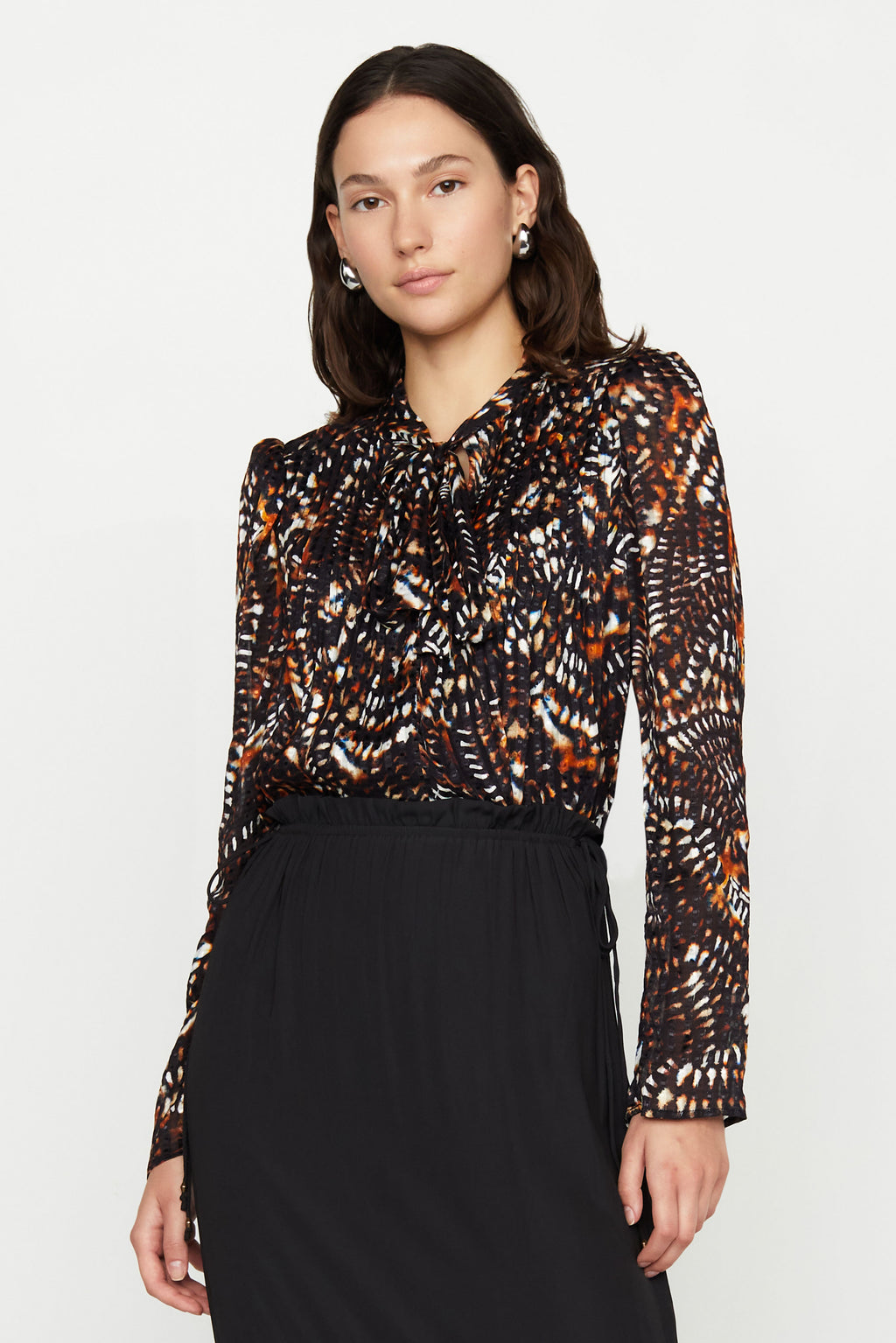 Patterned blouse with flowy long sleeves, tie neck options as bow or knotted 