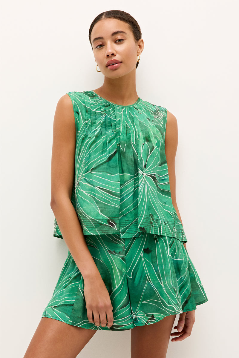 Sleeveless green top with a bold leaf print and pleated neckline