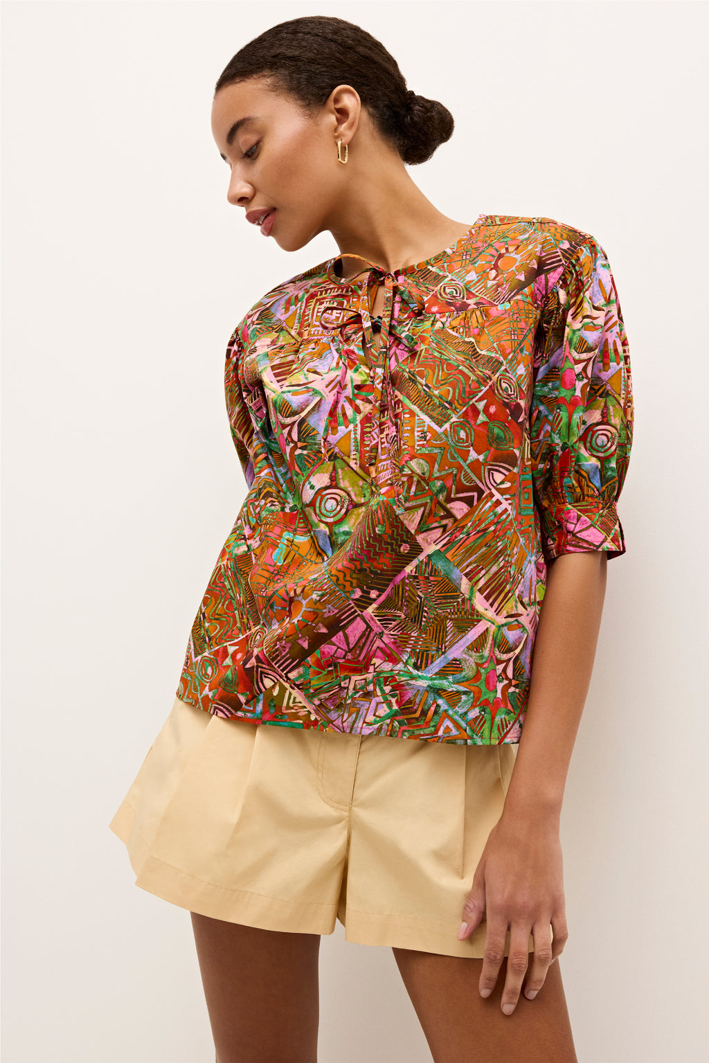 Colorful abstract print blouse with a relaxed fit and three quarter sleeves, with a tie neckline 