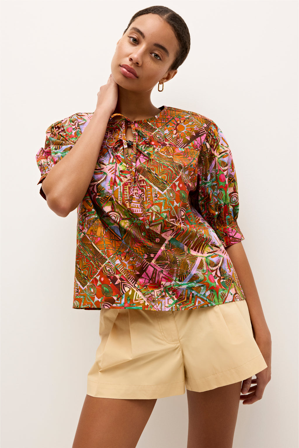 Multicolor geometric patterned top with earthy tones and pink accents, designed in a a lightweight fabric 