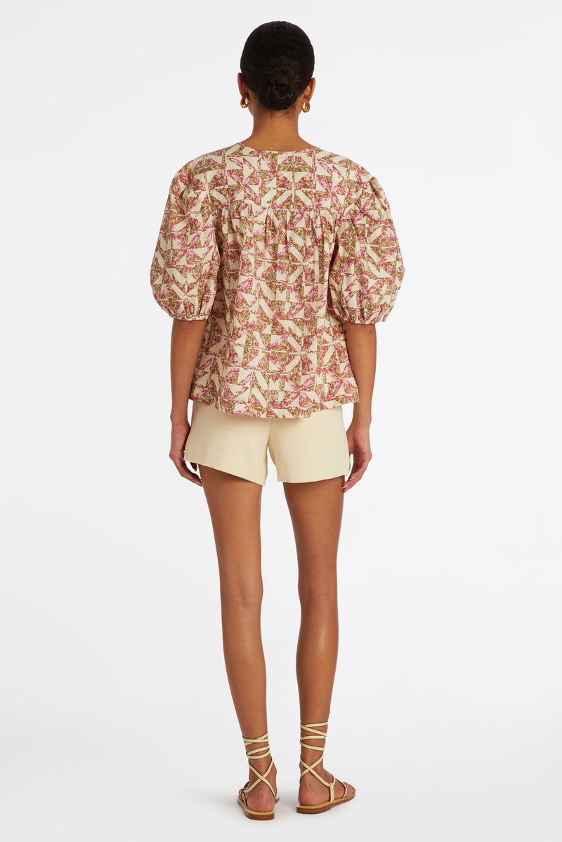 Puff sleeve top in a pink and white kaleidoscope print 