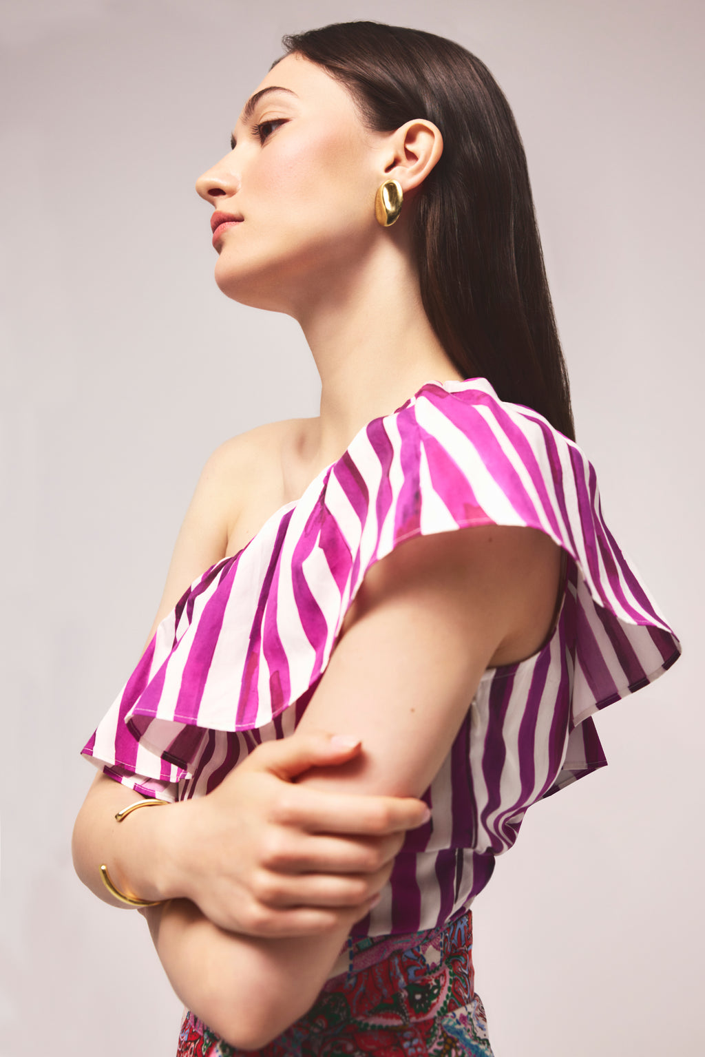 Striped asymmetrical blouse with a dramatic ruffled neckline 