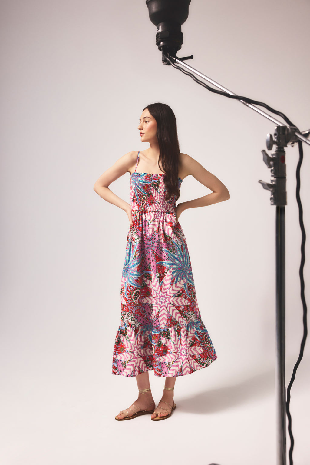 Smocked midi dress with spaghetti straps and a vibrant, multicolored botanical print 