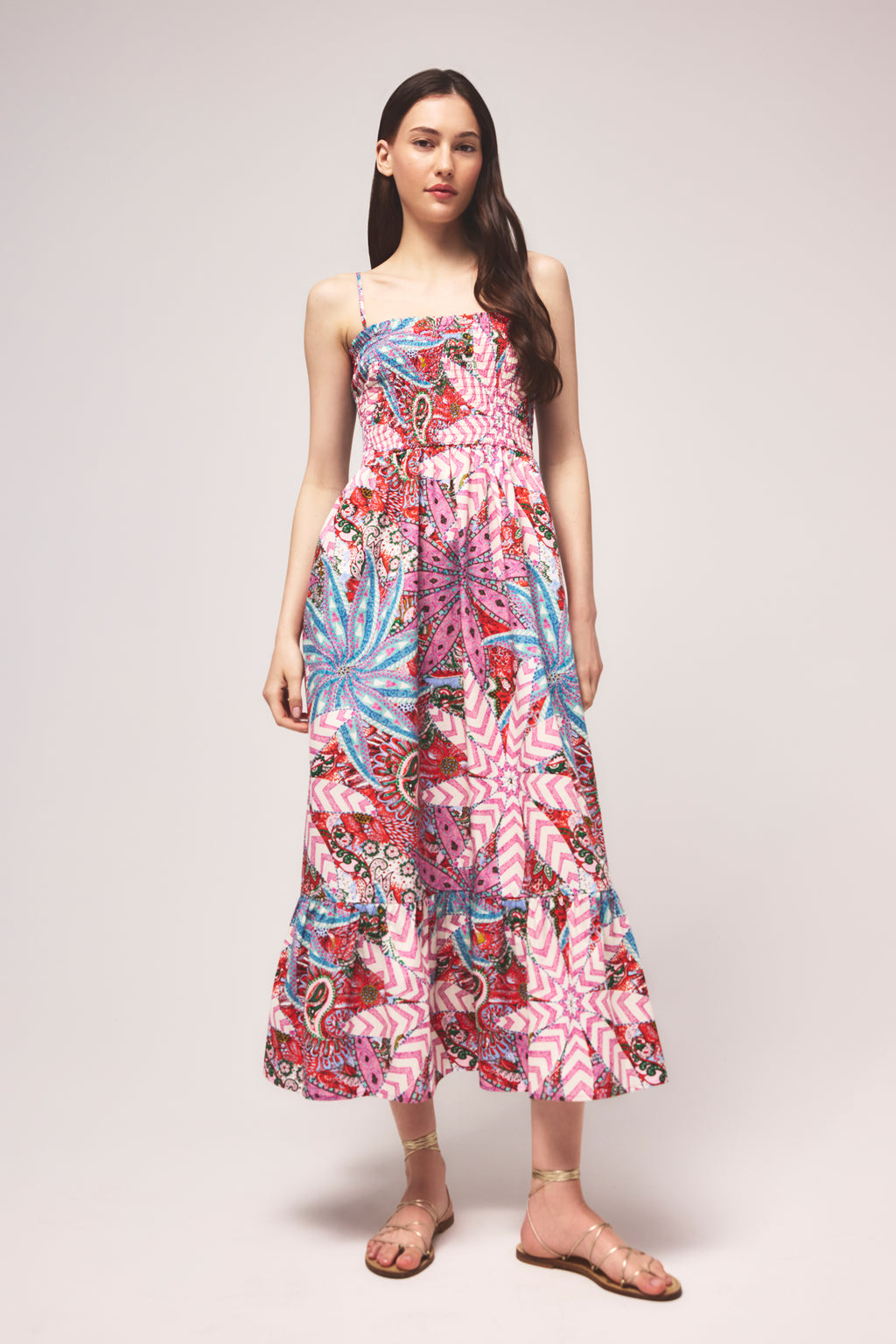 Flowy tiered sundress with a bold pink, red, and blue floral design 