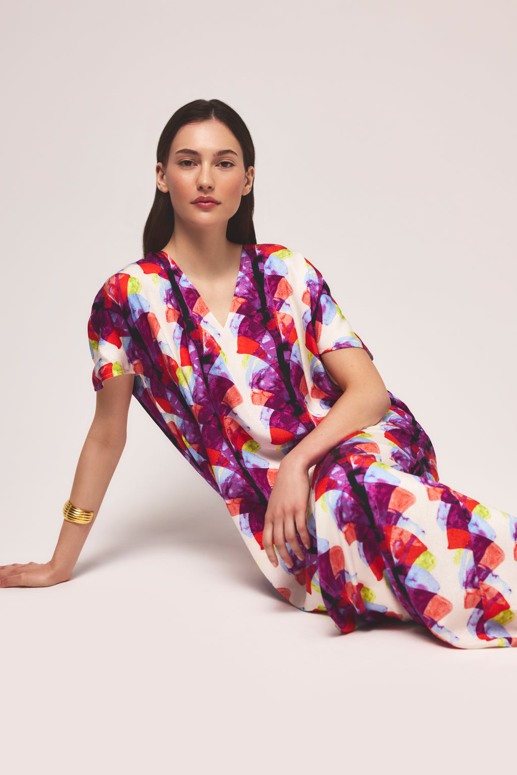 Colorful printed caftan with fan motif in shades of purple, red, and orange 