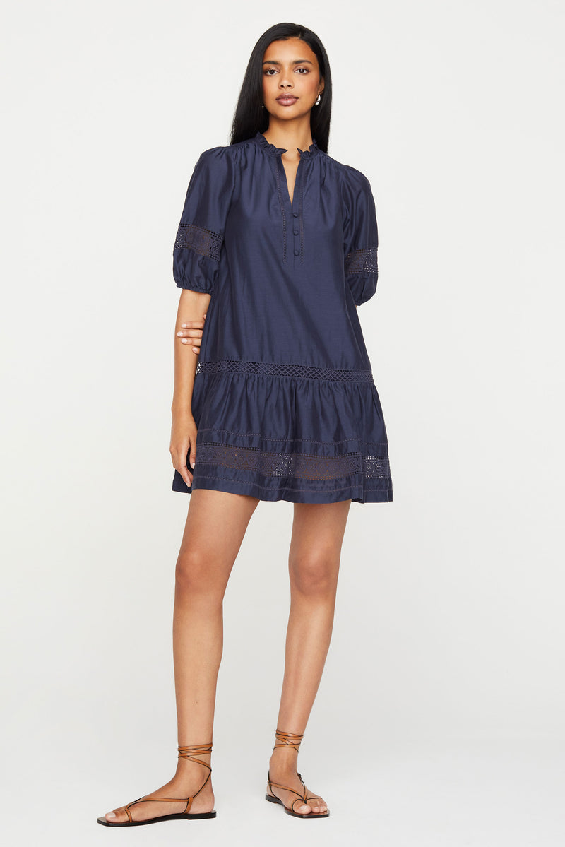 Short dress with lace detailing on the skirt and bubble sleeves in a solid midnight ink color