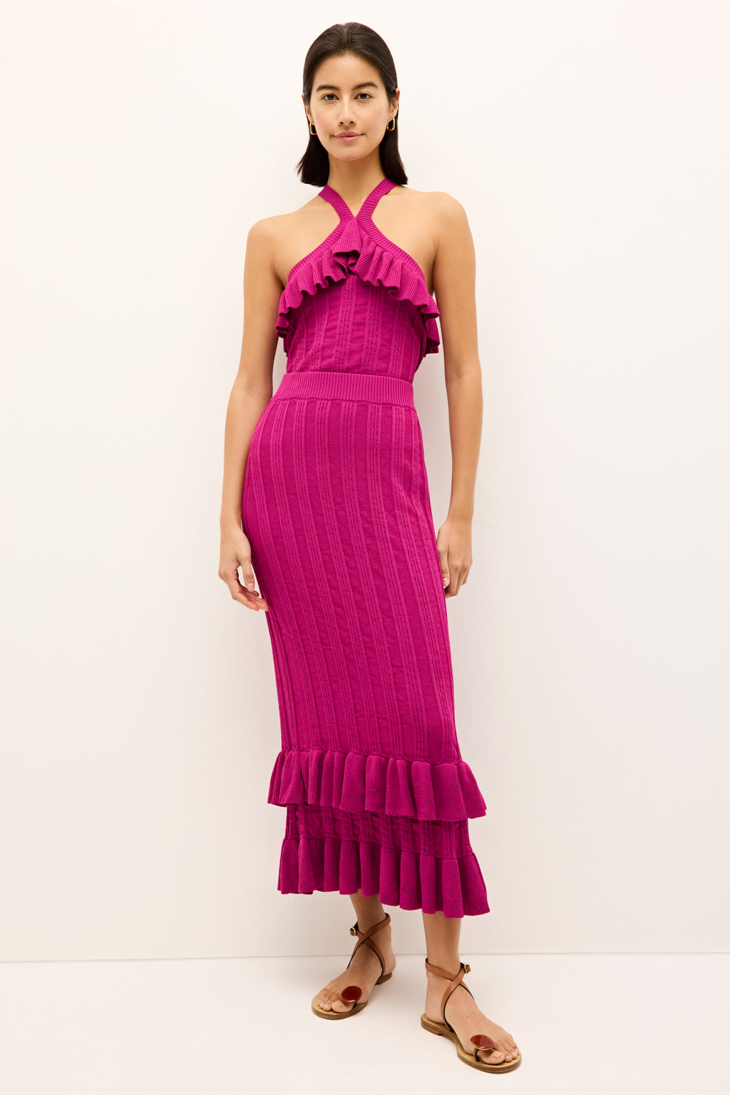 Vibrant pink midi length skirt with textured pleats and double fringe hem 