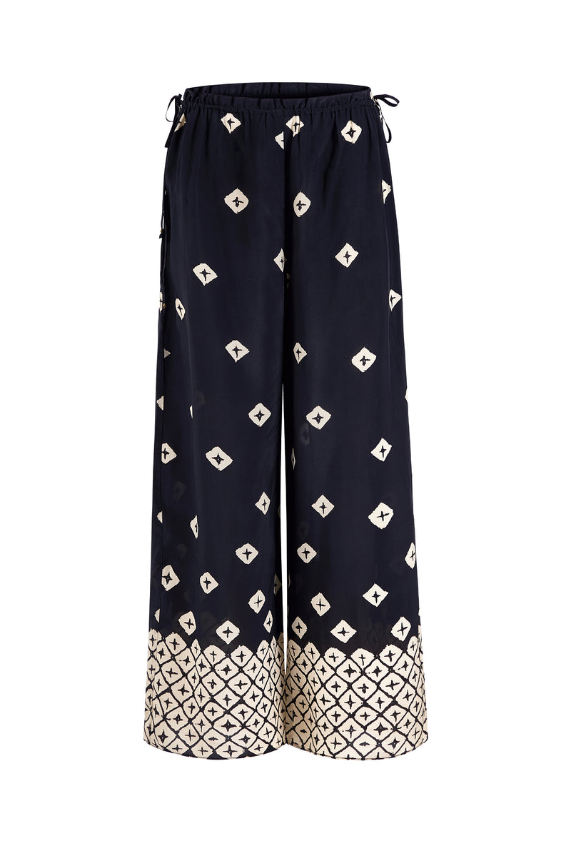 Lightweight patterned trousers with a bold tile print at the cuffs 