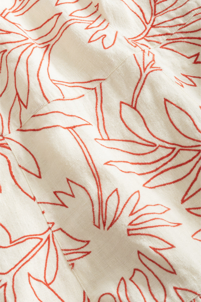Lightweight cream dress with red tropical leaf outlines and gathered waist detail 