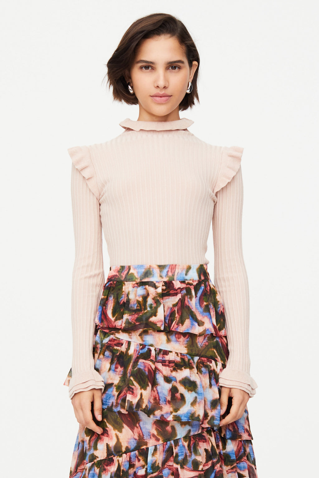 Pink turtleneck with ruffle details on shoulders and neck