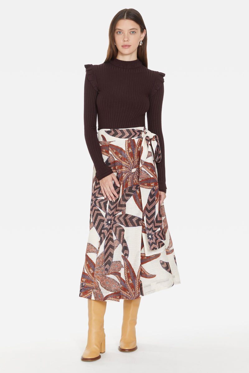 Traditional wrap skirt with long tie belt at the waist in a brown and red oversized floral print