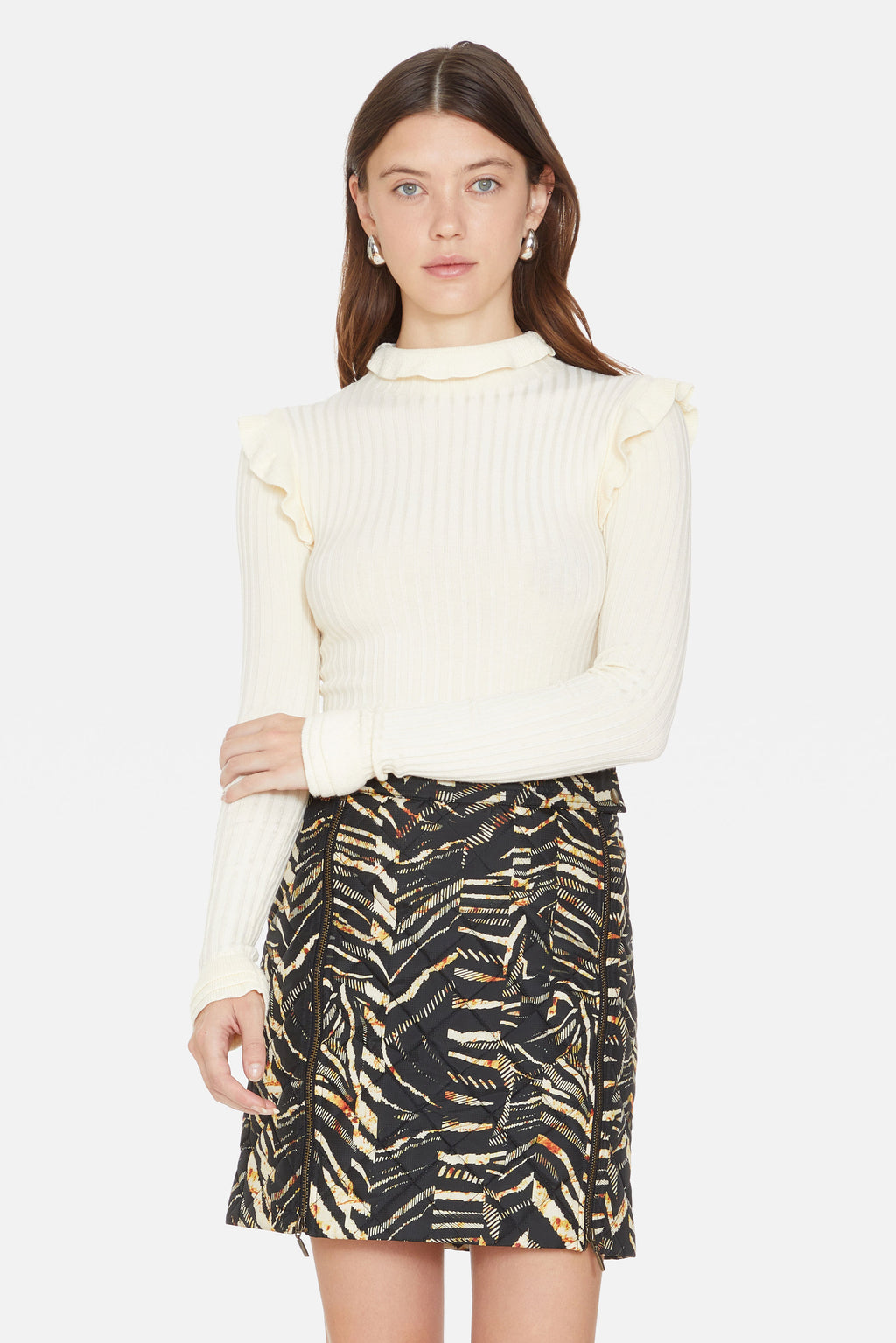 White turtleneck with ruffle details on shoulders and neck