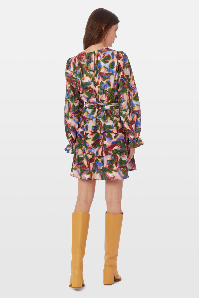 Abstract floral printed dress with a v neckline, long cuffed sleeves, and layered tier skirt