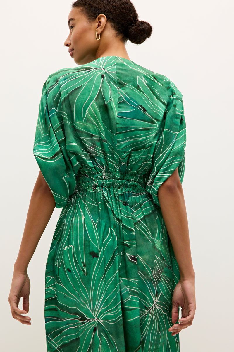 Short sleeve green dress with ruched bodice and graphic botanical pattern 