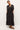 Relaxed fit black midi dress with white vertical stripes and a gathered waist