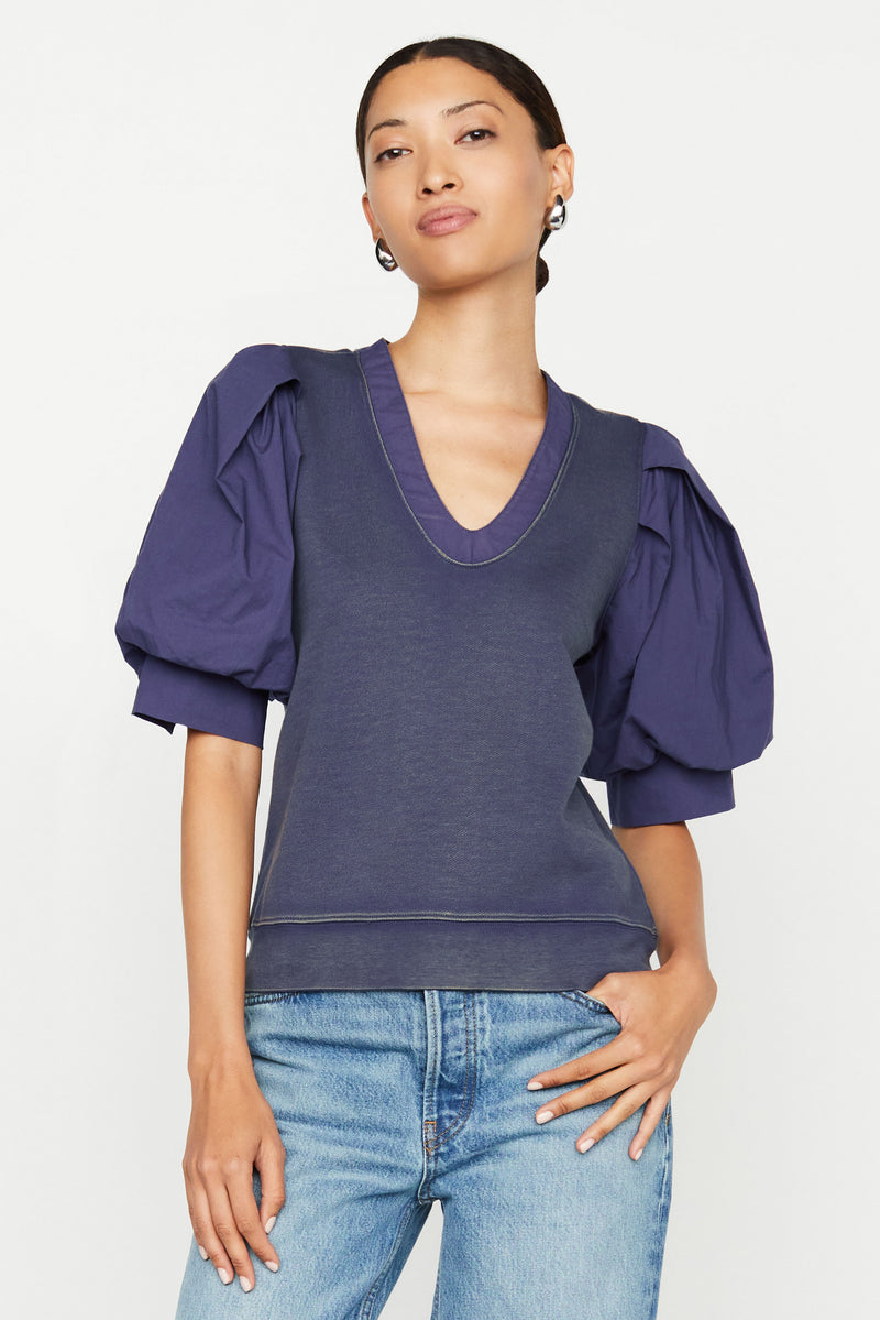 Navy top with straight silhouette with v-neckline and puff sleeves