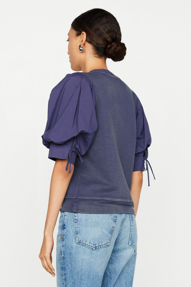 Puff sleeve top with cuffed sleeve and bows at the back of the sleeve 