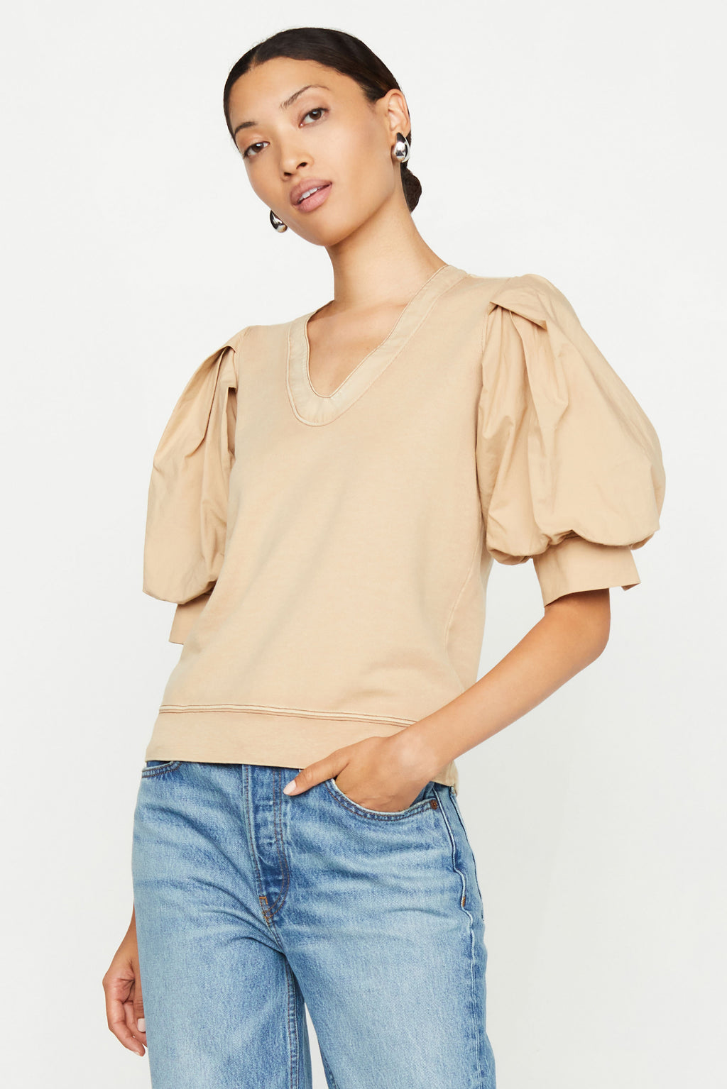 Beige top with a straight silhouette with v-neckline and puff sleeves
